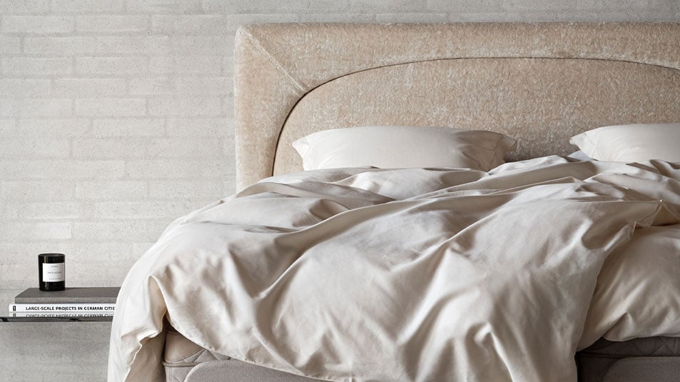 An adjustable bed with dual-base construction and customizable comfort zones.